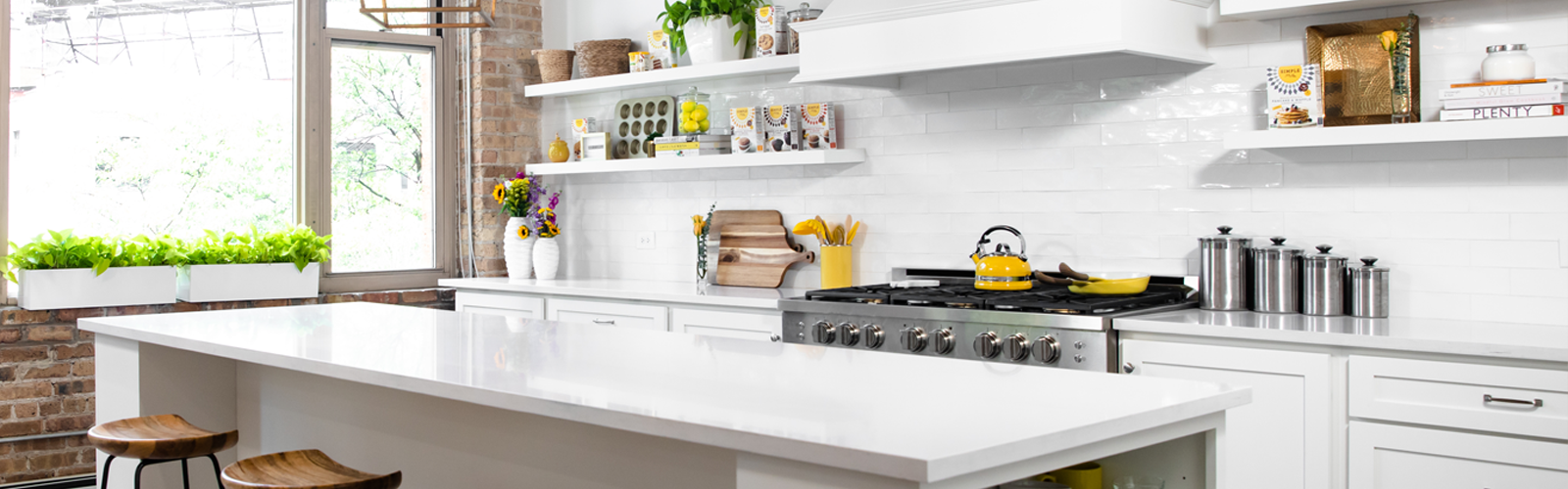 All white bright airy kitchen with yellow accents and Simple Mills products on shelves