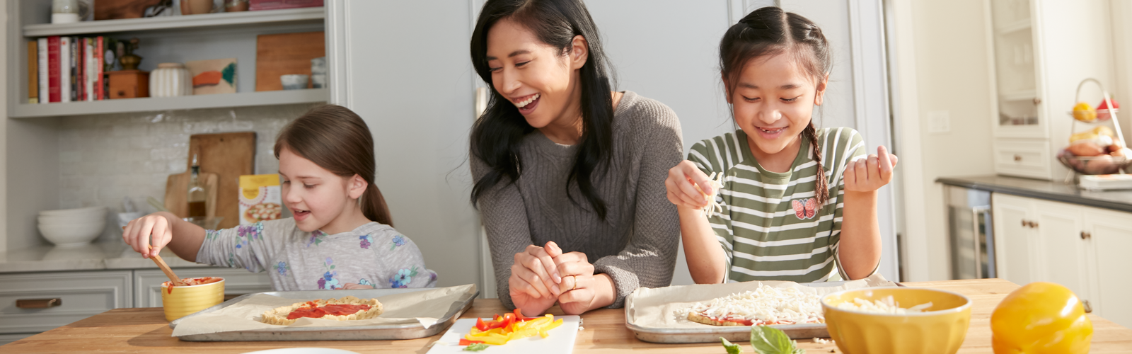 Family making pizzas using almond flour baking mix Pizza Dough