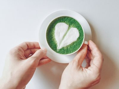Cup of matcha green tea, decorated with a white foam heart pairs well with mild flavors