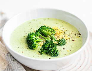 Cheesy vegan broccoli soup served with Almond Flour Crackers Sea Salt