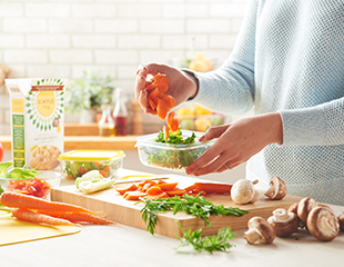 Person chopping up kale on a cutting board to use in a healthy recipe