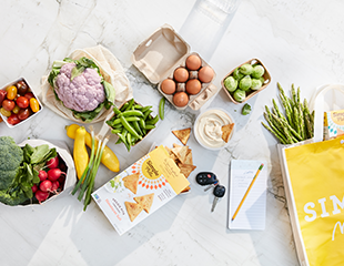 Healthy ingrdients, shopping list, Simple Mills reusable bag and Veggie Pita Crackers on a counter