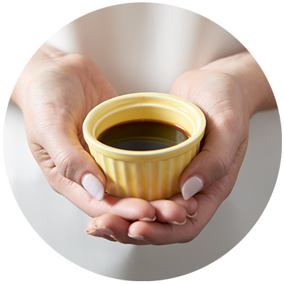 Vanilla Extract ingredient being cradled in a bowl in hands, nothing artificial ever 