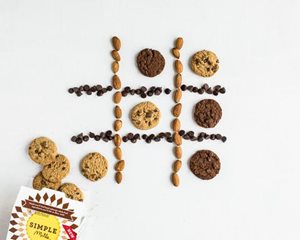Tic Tac Toe board made up of almonds, chocolate chips and Simple Mills crunchy cookies