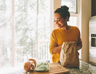 Woman in yellow sweater smiling,  excited to make recipes