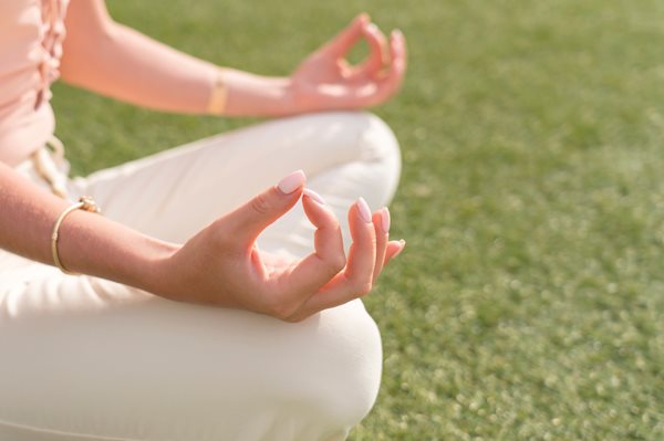 Person sitting in meditative yoga pose 