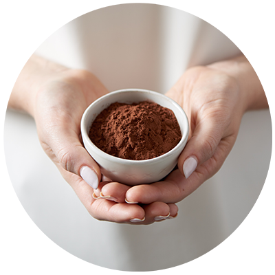 Cocoa ingredient being cradled in a bowl in hands, nothing artificial ever