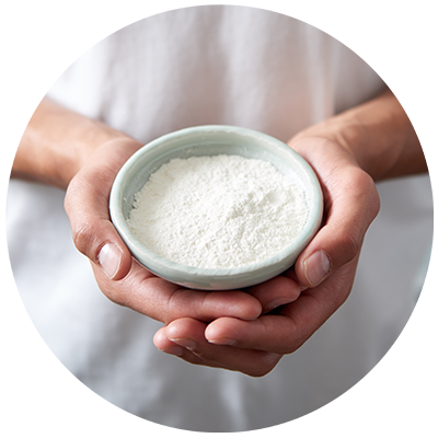 Coconut Flour ingredient being cradled in a bowl in hands, nothing artificial ever 