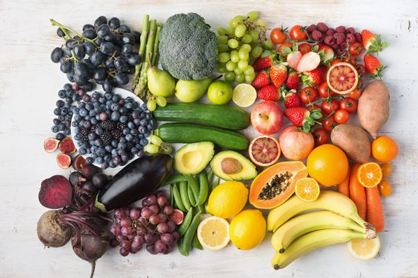 shutterstock_1034460058.jpg Variety of vegetables and fruits in a rainbow of colors aranged artistically on a neutral background