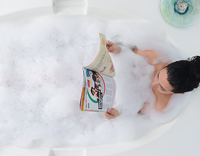 a.png Mother enjoying bubble bath in bath tub reading a magazine