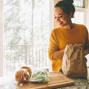 Woman in yellow sweater smiling,  excited to make recipes