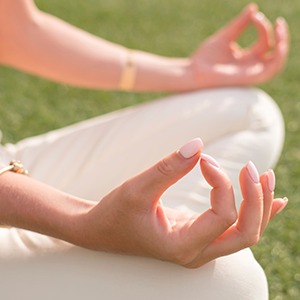 Person sitting in meditative yoga pose 