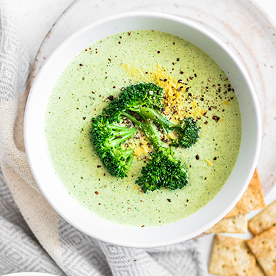 Cheesy vegan broccoli soup served with Almond Flour Crackers Sea Salt