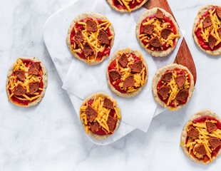Array of mini pizzas on countertop made using Simple Mills Pizza Dough Mix