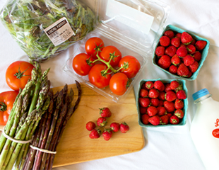 Locally grown produce including asparagus, tomatoes lettuce and berries 