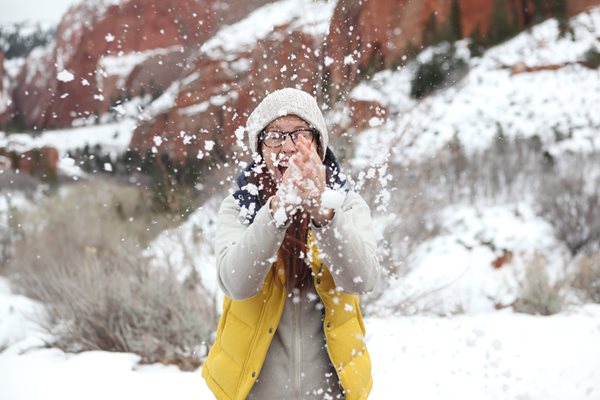 Holiday guest enjoying playing with snow 