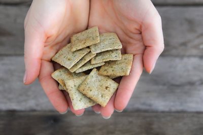 Gluten free almond flour crackers cradled in hands 